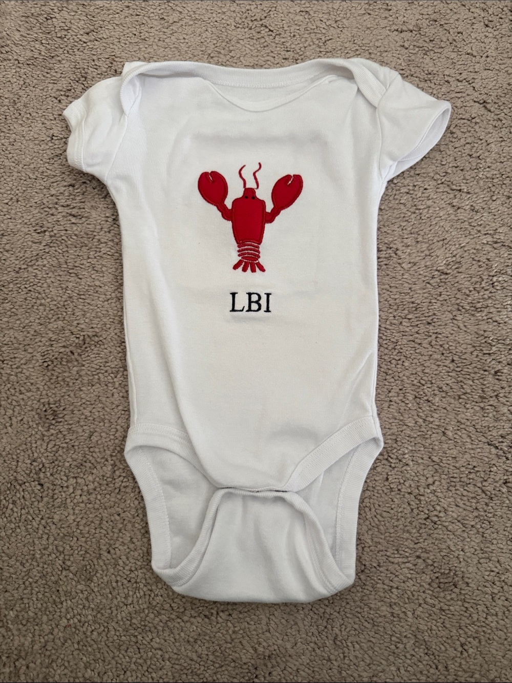 White Kids One-Piece Bodysuit with Red Lobster Graphic